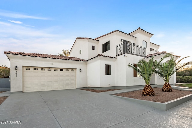 mediterranean / spanish-style house with a balcony and a garage