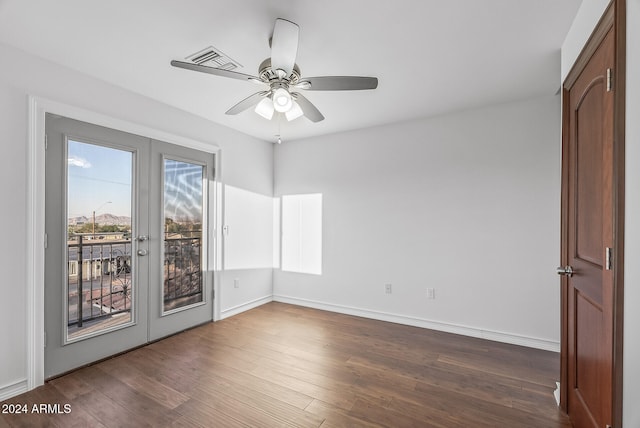 spare room featuring french doors, ceiling fan, and dark hardwood / wood-style flooring