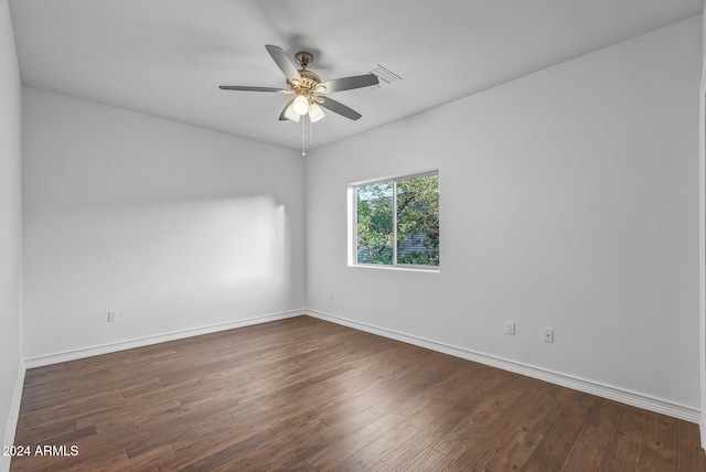 spare room with ceiling fan and dark hardwood / wood-style flooring