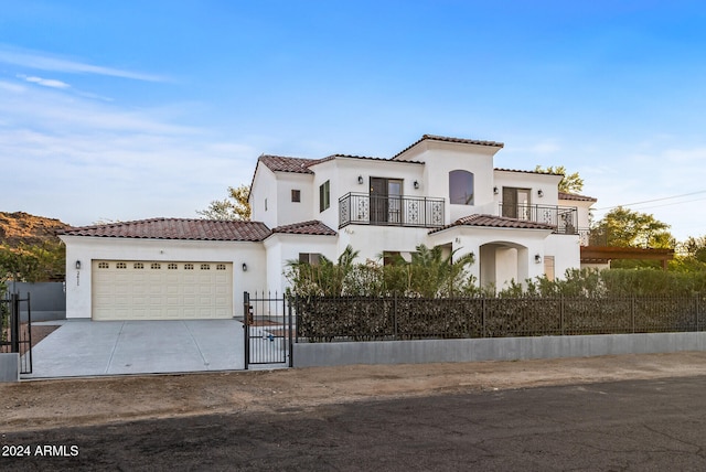 mediterranean / spanish house with a garage and a balcony