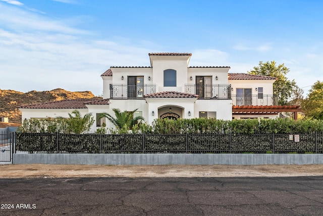 mediterranean / spanish home with a balcony and a mountain view