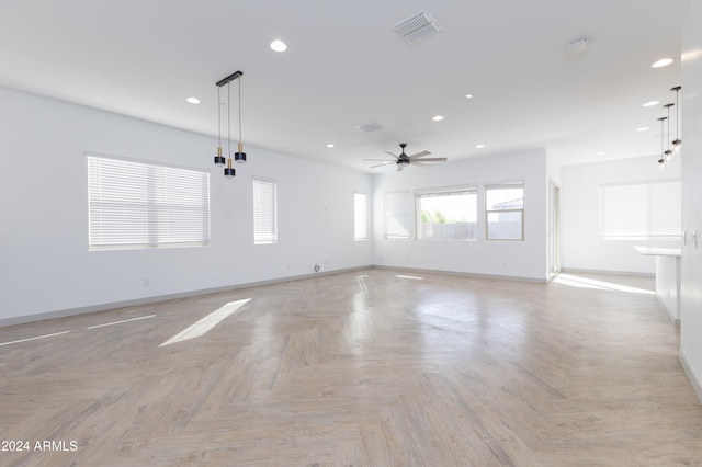 empty room featuring ceiling fan and light parquet floors