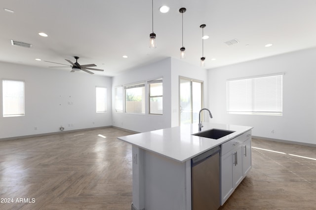 kitchen with a center island with sink, ceiling fan, dishwasher, hanging light fixtures, and sink