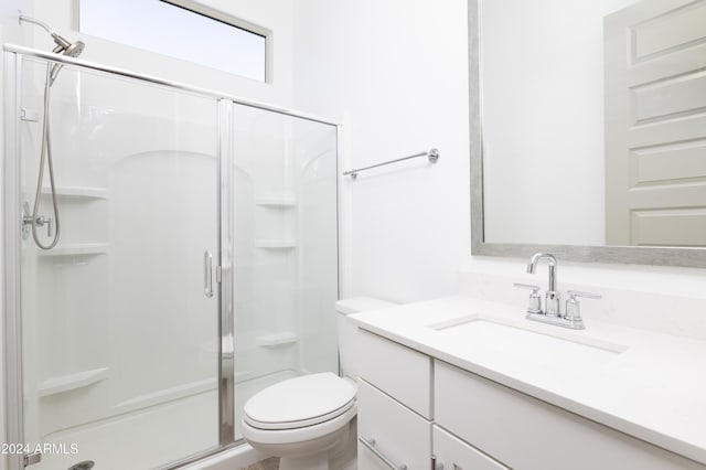 bathroom with toilet, an enclosed shower, and vanity