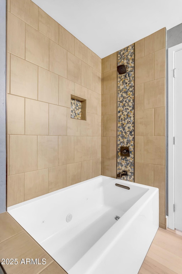 bathroom with a bath and tile walls