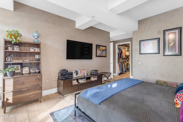 bedroom with a walk in closet and a closet