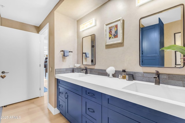 bathroom with vanity and hardwood / wood-style flooring