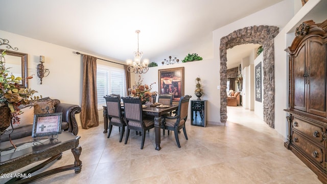 tiled dining room featuring vaulted ceiling and a notable chandelier