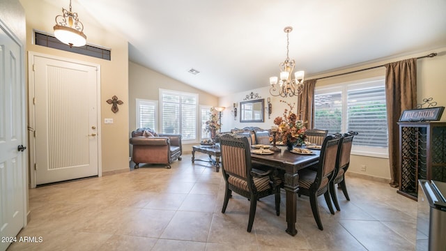 dining space with light tile patterned floors, a wealth of natural light, and vaulted ceiling