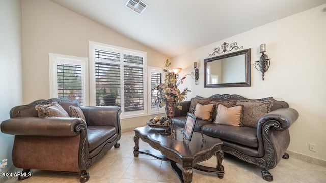 tiled living room featuring lofted ceiling