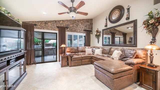 living room with ceiling fan and vaulted ceiling