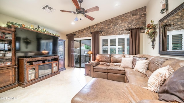 tiled living room featuring ceiling fan and high vaulted ceiling