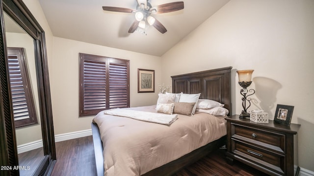 bedroom featuring ceiling fan, dark hardwood / wood-style flooring, and vaulted ceiling