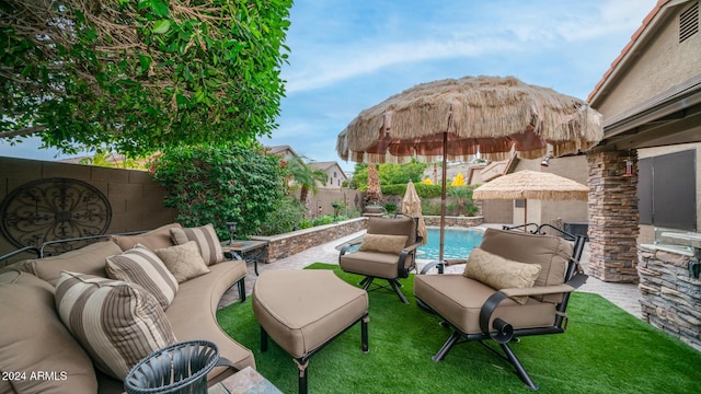 view of patio / terrace featuring an outdoor hangout area and a fenced in pool