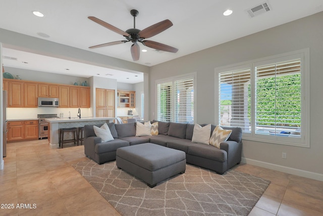 living area with a ceiling fan, light tile patterned flooring, recessed lighting, and baseboards