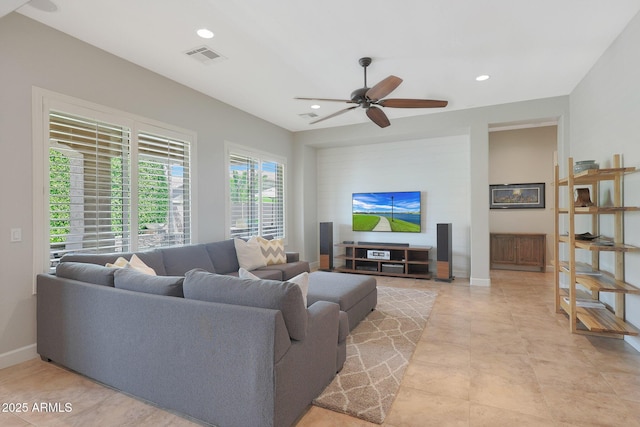 living area with a ceiling fan, recessed lighting, and baseboards