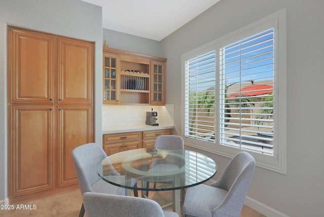 dining area featuring light tile patterned flooring and baseboards