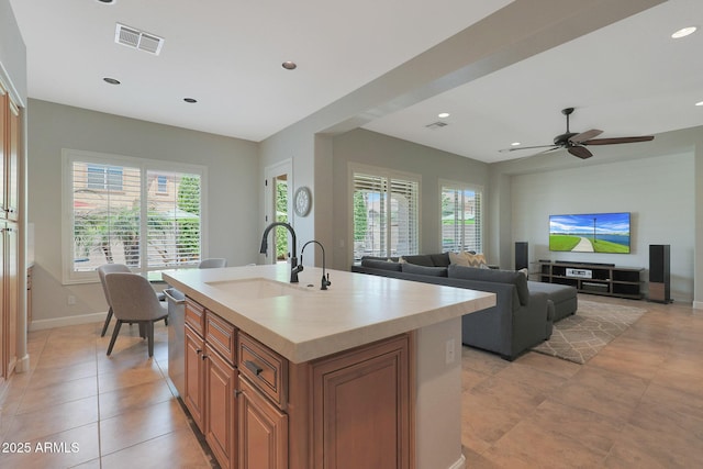 kitchen featuring a sink, brown cabinets, healthy amount of natural light, light countertops, and recessed lighting
