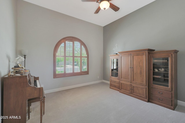 bedroom with light colored carpet, baseboards, a ceiling fan, and lofted ceiling