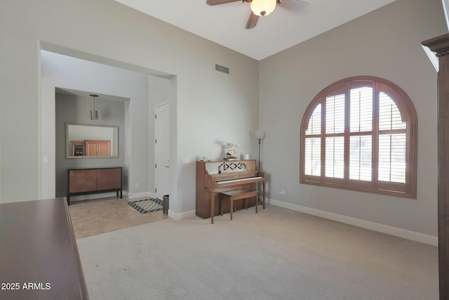 sitting room featuring ceiling fan, baseboards, and carpet floors