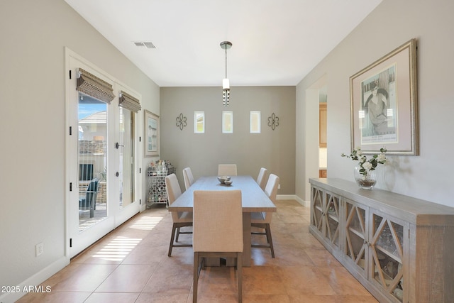 dining area featuring healthy amount of natural light, light tile patterned floors, french doors, and baseboards