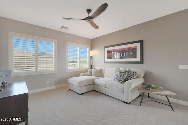 living room with ceiling fan, carpet flooring, and baseboards