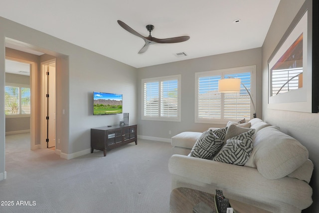 living room featuring ceiling fan, baseboards, carpet flooring, and healthy amount of natural light