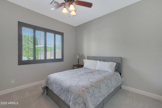 carpeted bedroom featuring baseboards and ceiling fan