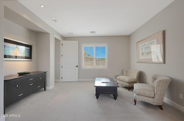 sitting room with light colored carpet and baseboards