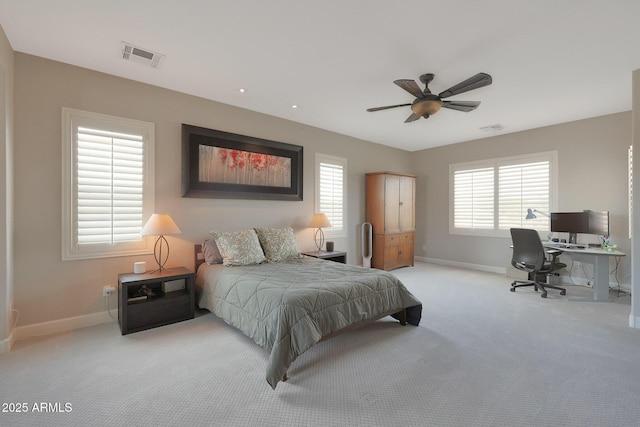 carpeted bedroom featuring baseboards, multiple windows, a desk, and a ceiling fan