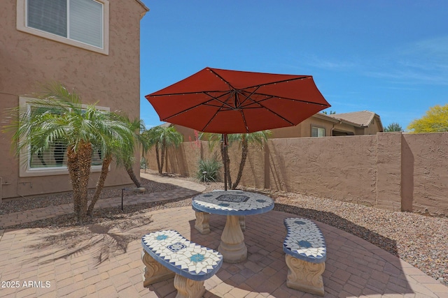 view of patio with a fenced backyard and a fire pit