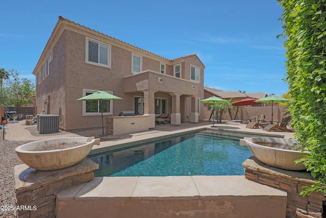 rear view of house with a patio and stucco siding