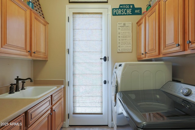 laundry room with cabinet space and washer and clothes dryer