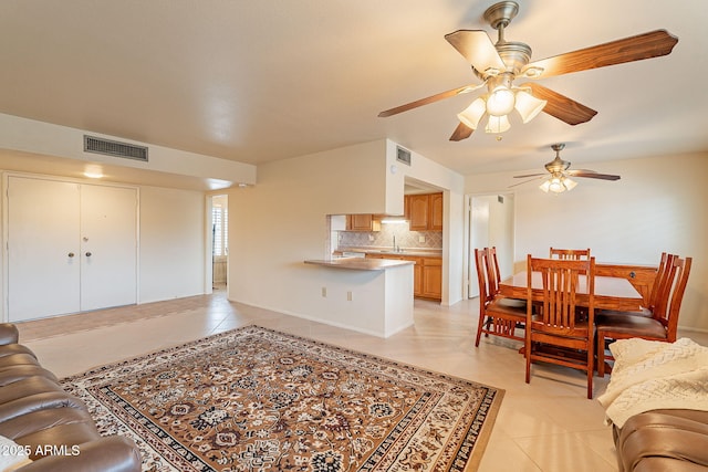 living room featuring sink and light tile patterned floors