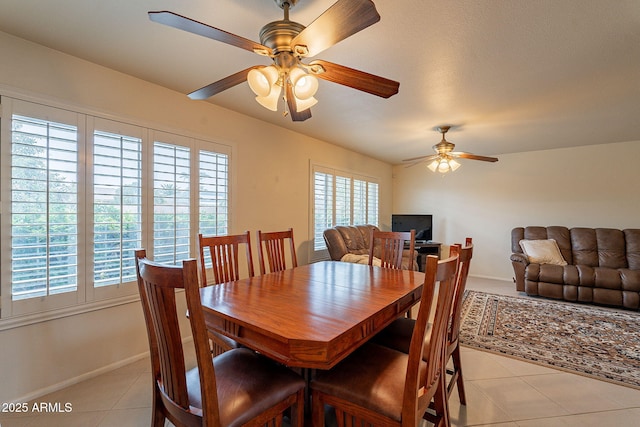 tiled dining room featuring ceiling fan