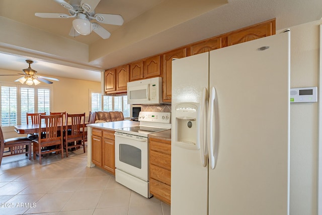 kitchen featuring ceiling fan, light tile patterned floors, backsplash, and white appliances