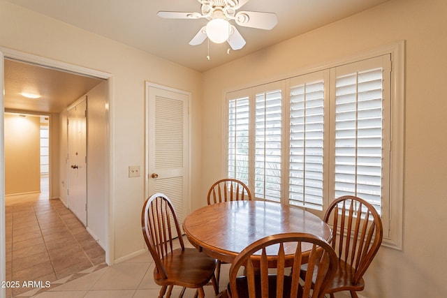 dining room with light tile patterned flooring and ceiling fan