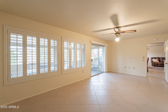 unfurnished room featuring light tile patterned floors and ceiling fan