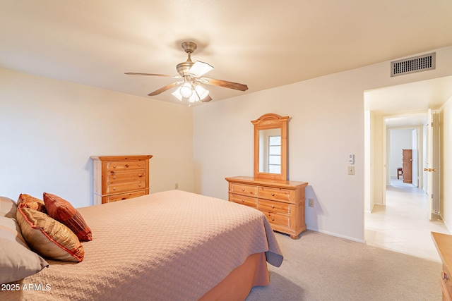 bedroom featuring ceiling fan and light carpet
