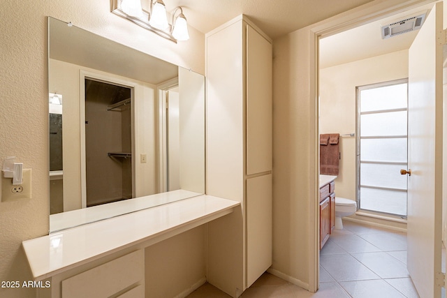 bathroom with vanity, toilet, and tile patterned flooring