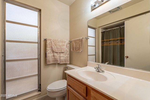 bathroom featuring vanity, a shower with curtain, and toilet