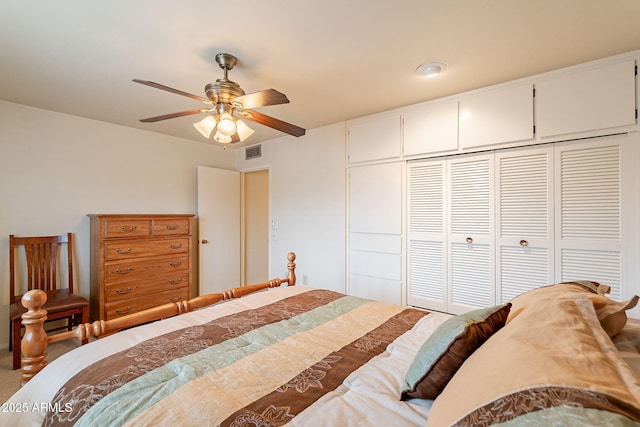 carpeted bedroom featuring a closet and ceiling fan