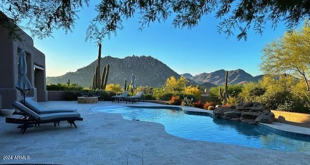 view of pool featuring a mountain view and a patio