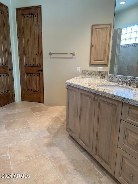 bathroom featuring vanity and a shower