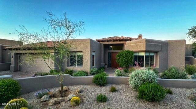 pueblo-style home with a garage