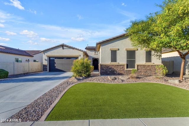 view of front of property featuring a front yard and a garage