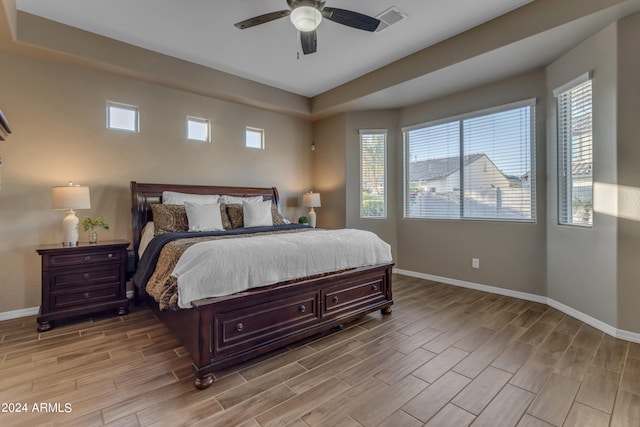 bedroom with light hardwood / wood-style floors and ceiling fan