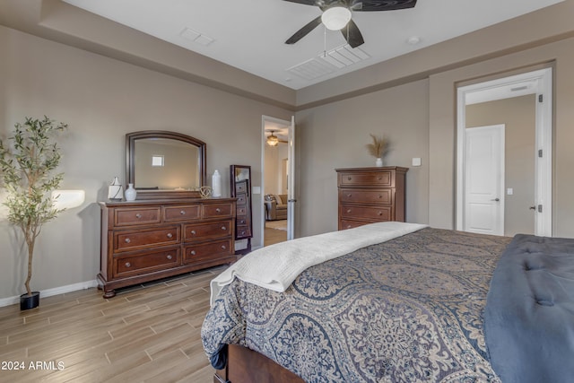 bedroom with light hardwood / wood-style floors and ceiling fan