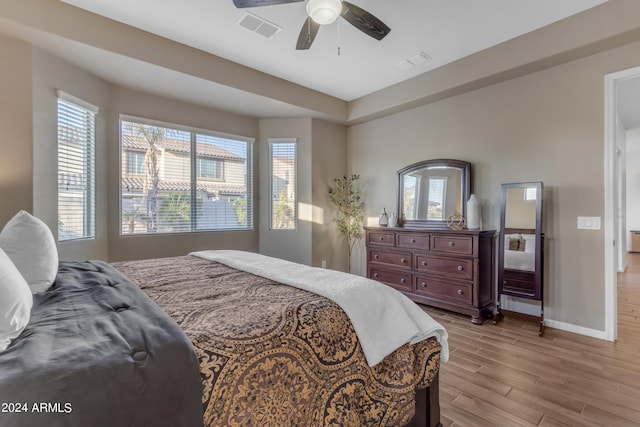 bedroom with ceiling fan and light wood-type flooring