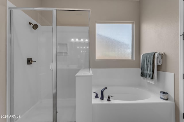 bathroom featuring separate shower and tub